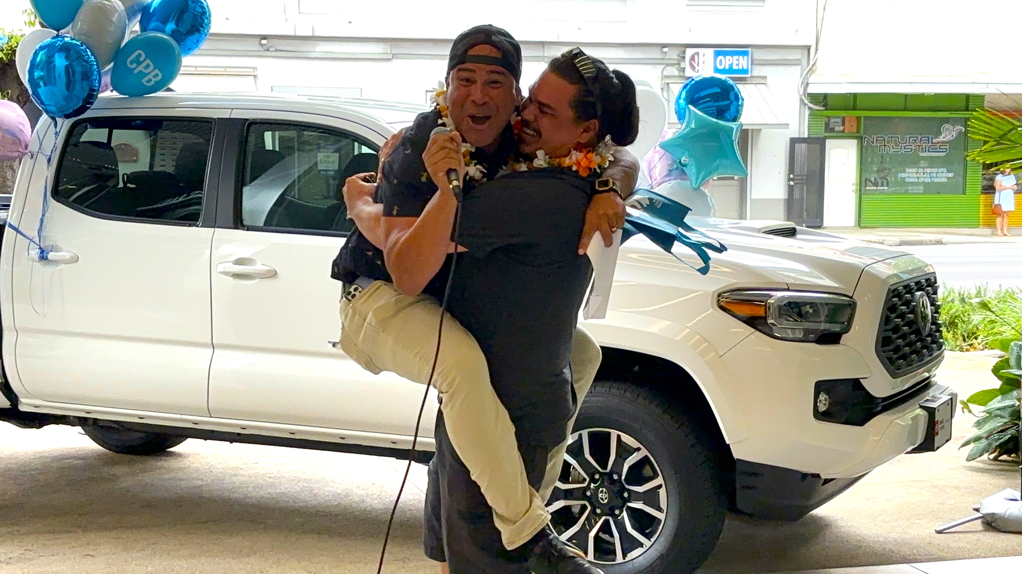 Magic Mike and Winner Austin Hug in front of truck