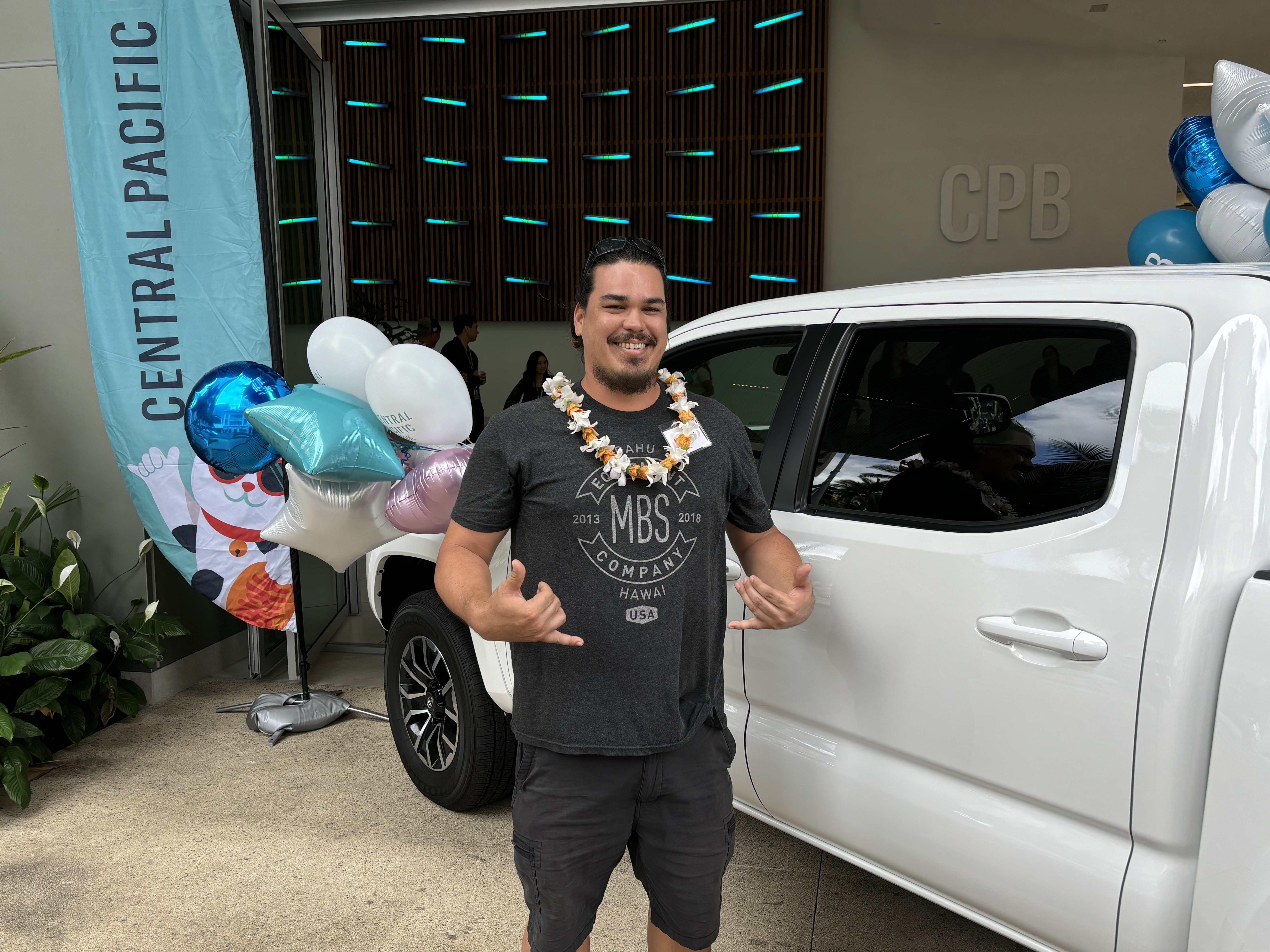 Austin Kehrer standing next to new truck